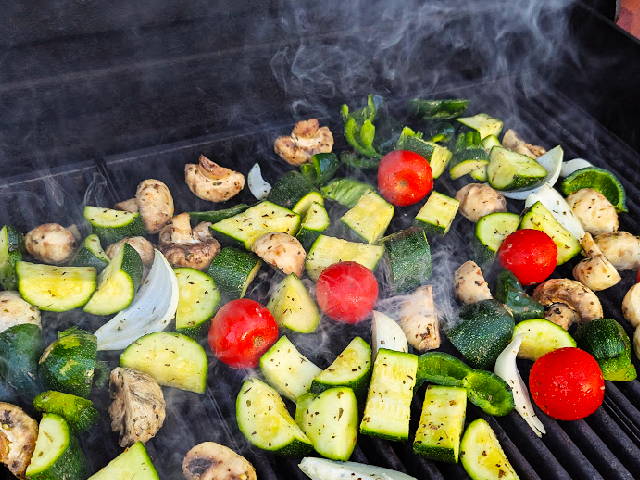 photo of various vegetables on a smoking hot grill