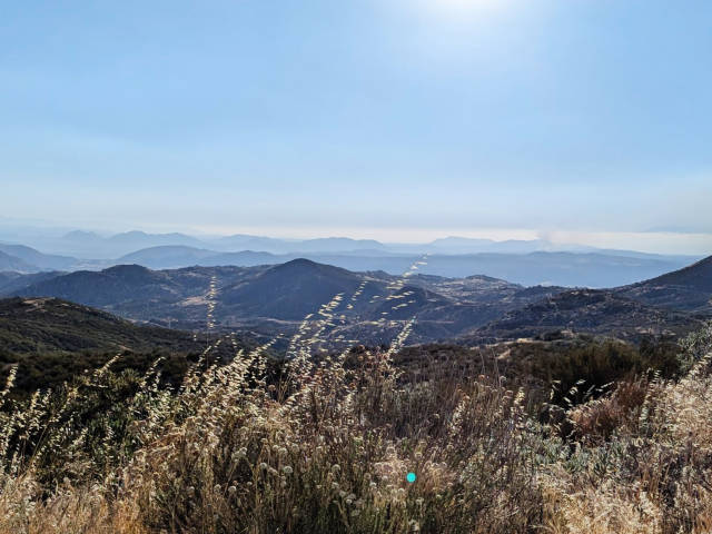 photo of a mountains extending to the horizon, diffrent shades of blue gray like a diorama