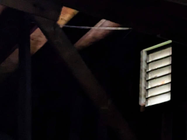 photo of light filtering through a vent in the attic