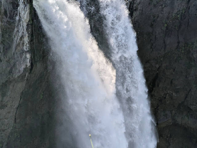 a waterfall against volcanic rock