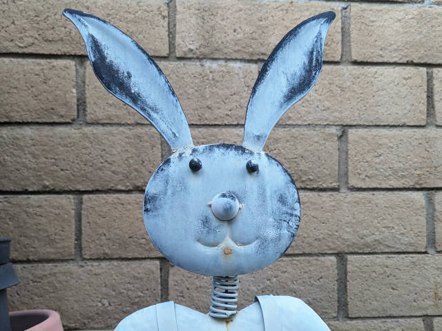 a funny bunny sculpture of tin and wire
