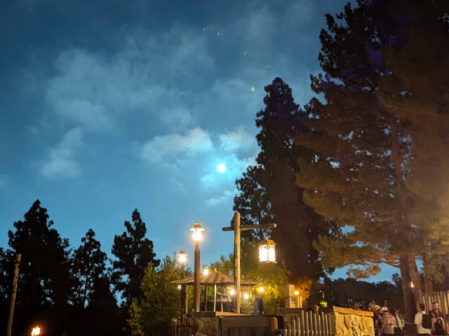 full moon with cloudy skies above disneyland