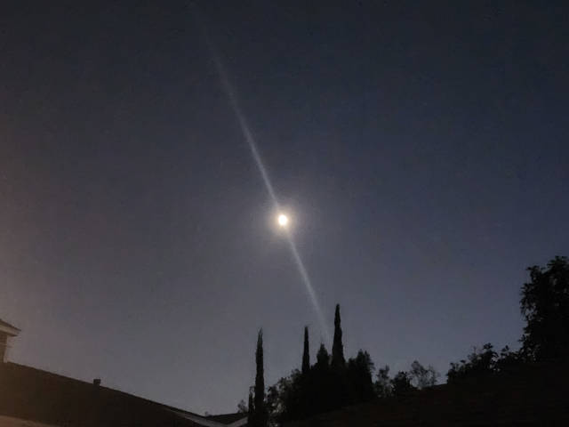 strange lens flare on the moon, like its slashed by light