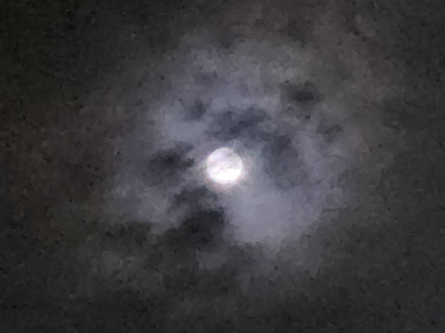 the moon, obscured by cloud, and massive amounts of phone camera noise reduction artifacts