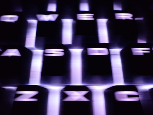 slow shutter moving across backlit computer keyboard