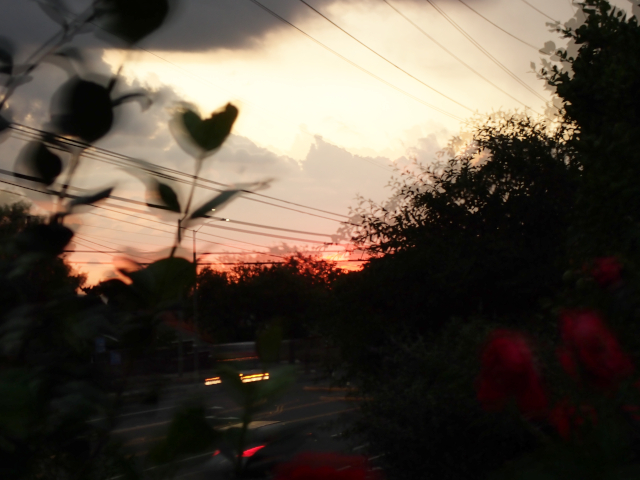 stacked image of a sunset and cars whizzing by