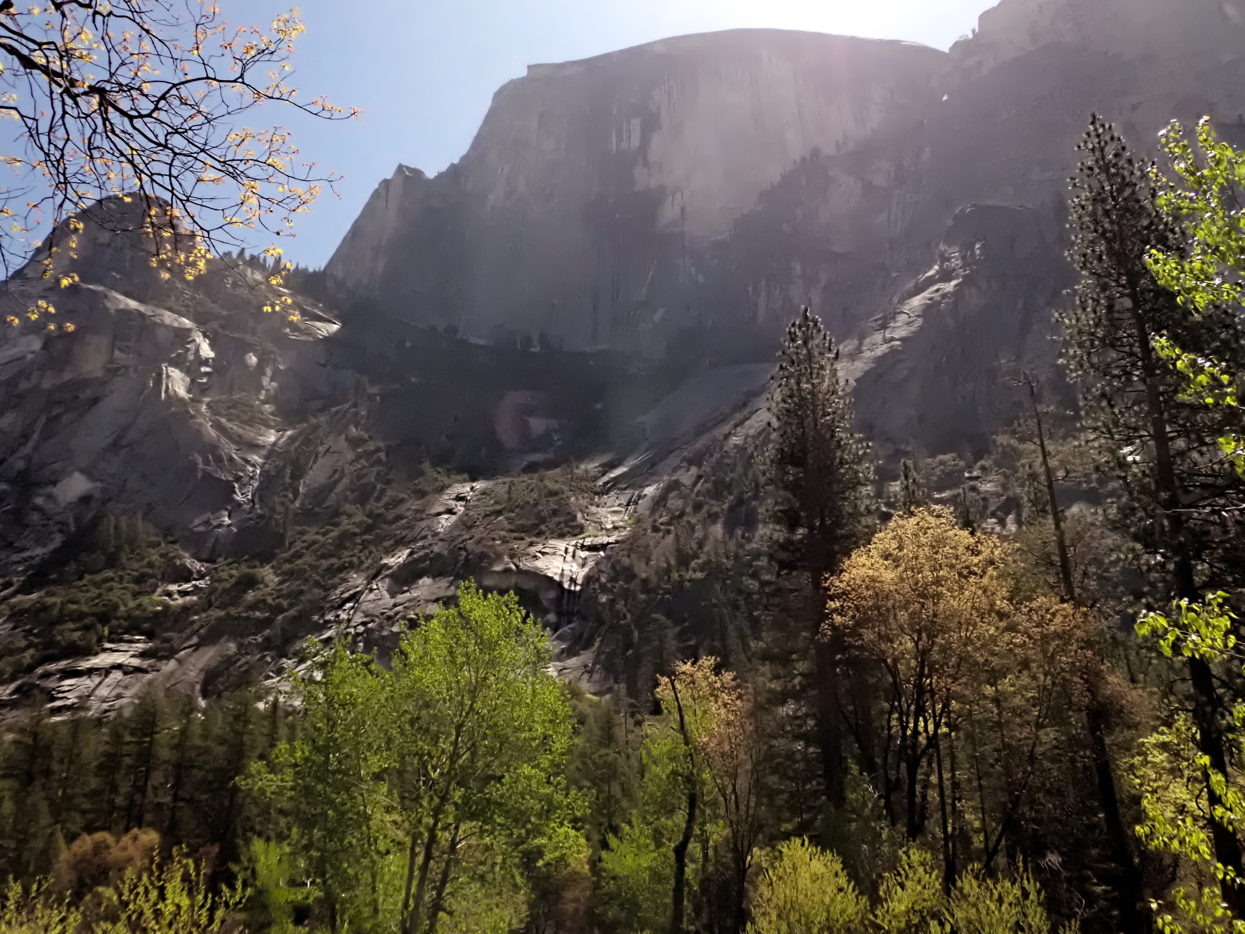 Bright sunlight shines above Half Dome in Yosemite Valley